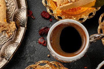 Cup of coffee and turkish pastries on dark surface
