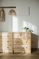 Part of children room with wooden chest of drawers