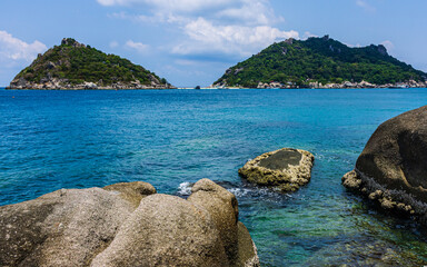 small green natural island view, crystal blue sea water and rock bay
