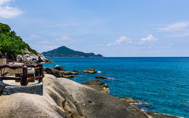 small green natural island view, rock bay, crystal blue water
