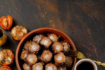 Cup of coffee and turkish pastries on dark surface