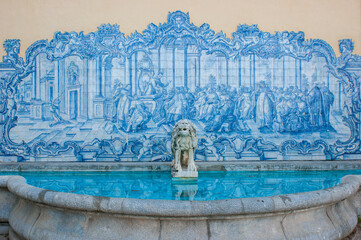 Beautiful fountain with blue tiles and an ornamental stone lion in Marechal Carmona park, Cascais, near Lisbon, Portugal