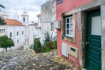 Cloudy day on the stairs and cobblestone floor near the church of Sao Miguel, in the Alfama district of Lisbon, capital of Portugal