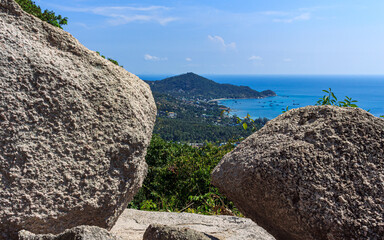 Island panoramic natural green view, small island and rocks foreground
