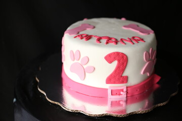 white cake whith pink words and number 2