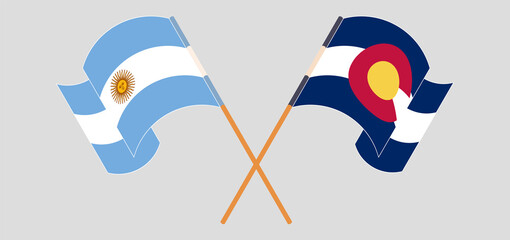 Crossed and waving flags of Argentina and The State of Colorado