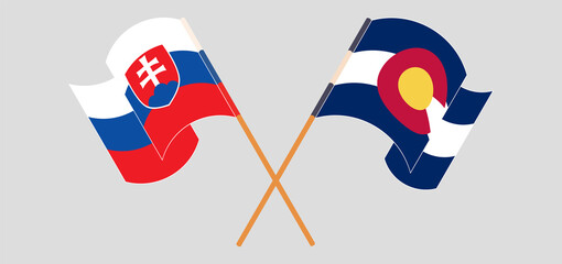 Crossed and waving flags of Slovakia and The State of Colorado