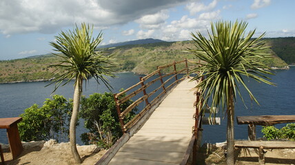 wooden bridge over the sea in bali. This place is in Nusa Penida