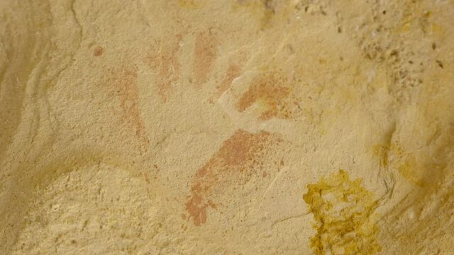 zoom in on ancient aboriginal hand print art on a rock shelter wall at dunns swamp  in wollemi national park of nsw, australia