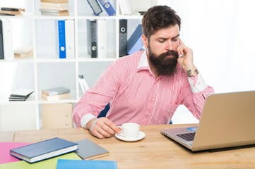 Naklejka premium Serious hipster run business online using laptop computer technology in modern office, busy