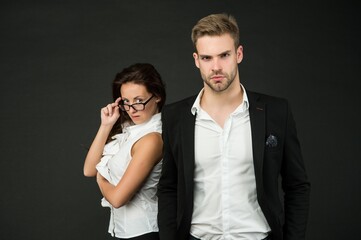 Professional couple of sexy woman and handsome man in formal wear dark background, fashion