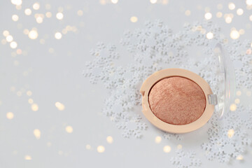 Blush for face and decorative snow on a white background. Isolated. Copy space. Cosmetic, bronzer, blush.