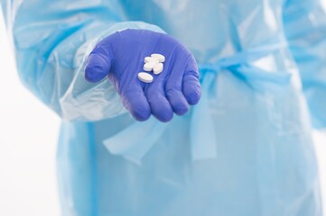 Fototapeta premium medical worker in protective costume isolated on white offer drug pills antibiotics and antipyretic from covid19 sars virus pandemic, coronavirus remedy