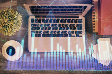 Stock market chart and top view computer on the table background. Multi exposure. Concept of financial analysis.