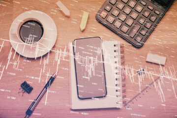 Multi exposure of forex graph hologram over desktop with phone. Top view. Mobile trade platform concept.