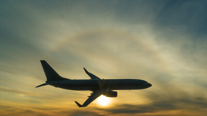 Silhouette of a flying plane on the background of a beautiful sunset. Airline concept, travel tourism, flight. copy space