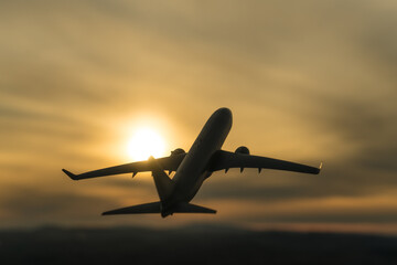 Fototapeta na wymiar Silhouette of a plane taking off on the background of the sunset. Airline concept, travel tourism, flight. copy space