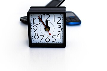 desktop clock on a blury background of old phones with buttons