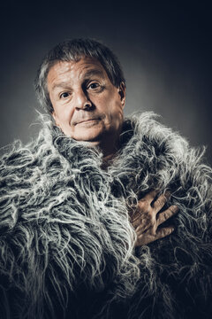 Solid middle-aged man in a fur mantle