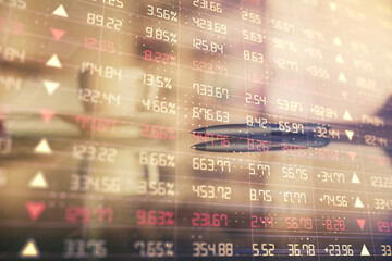 Obraz premium Double exposure of forex chart over coffee cup background in office. Concept of financial analysis and success.