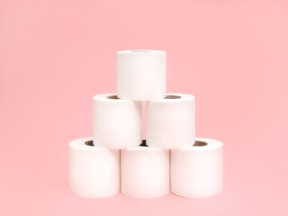 Toilet paper stack Photo in minimal style Five rolls of white soft toilet paper on light pink backdrop