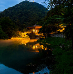 Fototapeta premium Beautiful night landscape with old pavilion on the water