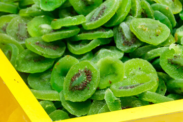 Candied fruit pieces of kiwi for sale in a market