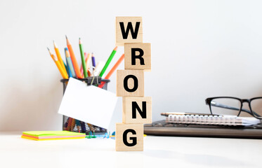 Wrong - word from wooden blocks with letters, incorrect false wrong concept, random letters around...