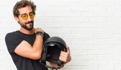 young man feeling in love, smiling, cuddling and hugging self, staying single, being selfish and...