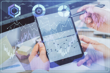 Double exposure of man's hands holding and using a phone and financial chart drawing. Market analysis concept.