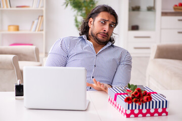 Young man in christmas concept at home