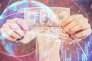 Multi exposure of forex graph drawing hologram and USA dollars bills and man hands. Technical Analysis concept.
