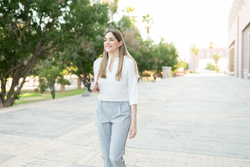 Happy professional woman walking to her office