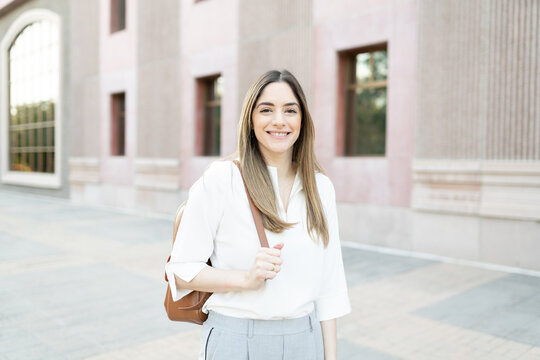 Happy businesswoman arriving at her office building