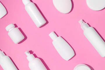 Mock up pattern for branding on pink background. Tubes, dispensers and jars. Cosmetics and dietary supplements for beauty and health. Flat lay