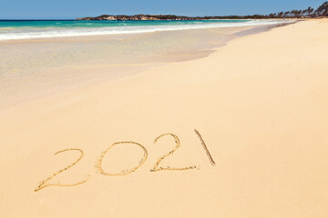 Inscription 2021 on sandy beach
