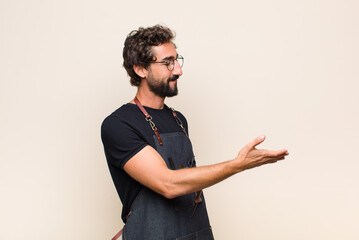 young man smiling, greeting you and offering a hand shake to close a successful deal, cooperation concept