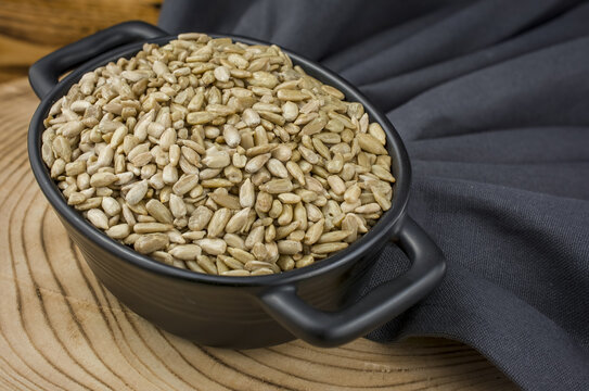Sunflower seeds in  bowl on wooden  background.