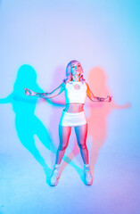 Young woman with pink hair dancing and having fun