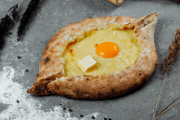 Khachapuri in Adjarian. Open pie with mozzarella and egg. Georgian cuisine