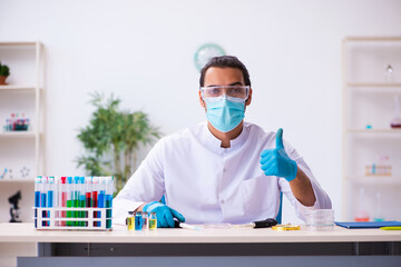 Young male chemist working in the lab