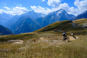 Extreem outdoor sport challenge in French Alps mountains in summer, riding downhill on sport bike on special bicycle path