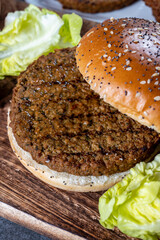 Making tasty vegetarian hamburgers from plant based grilled burgers, fresh bakes buns and organic vegetables