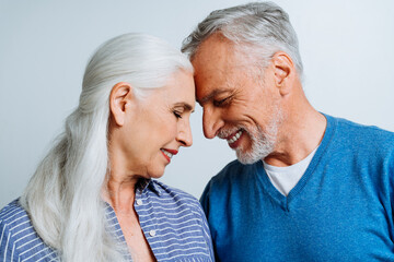 Happy senior couple posing in a studio for a photoshooting