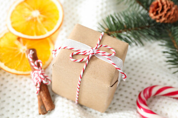 Fototapeta na wymiar Christmas gift box and decor on white crocheted background, closeup