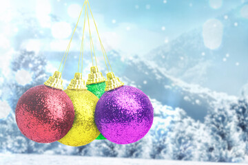 Colorful Christmas ball hanging with snowfall background