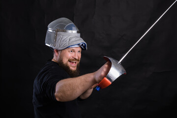 Middle aged bearded man with epee and helmet