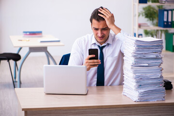 Young male employee unhappy with excessive work