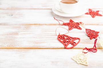 Christmas or New Year composition. Decorations, red stars, bells, on a white wooden background. Side view, copy space, selective focus.