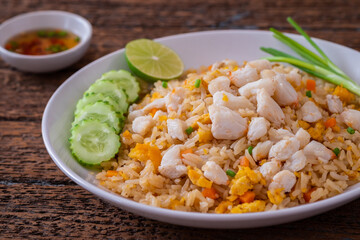 Fried rice with crab on white plate and chili fish sauce in bowl